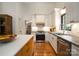Modern kitchen with white cabinets, stainless steel appliances, and an island with a breakfast bar at 1408 Rinehart Ct, Charlotte, NC 28270