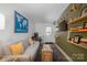 Comfortable living room with modern lighting, couch, shelving, and desk area at 1408 Rinehart Ct, Charlotte, NC 28270