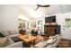 Open living room features a brick fireplace, coffered ceilings, wood floors and modern decor at 1408 Rinehart Ct, Charlotte, NC 28270