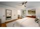 Bright main bedroom featuring hardwood floors, a ceiling fan, and an ensuite bathroom at 1408 Rinehart Ct, Charlotte, NC 28270