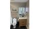 Bright bathroom with wood-look vanity, sleek sink, and modern, decorative mirror with LED lighting at 1427 Kinks Ln # 47, Maiden, NC 28650