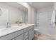 This bathroom has a double vanity with a tiled floor and a shower-tub combo at 14407 Cardwell Hill Ln, Charlotte, NC 28278