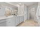 Luxurious bathroom featuring double sinks, a large mirror, and modern fixtures at 14407 Cardwell Hill Ln, Charlotte, NC 28278