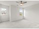 Neutral bedroom with large windows offering natural light, a ceiling fan, and plush carpet at 14407 Cardwell Hill Ln, Charlotte, NC 28278