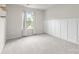 This bedroom offers soft carpet flooring, natural lighting, and modern trim work at 14407 Cardwell Hill Ln, Charlotte, NC 28278