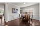 Charming dining room featuring modern wainscoting, stylish lighting, and dark wood floors at 14407 Cardwell Hill Ln, Charlotte, NC 28278