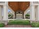 Inviting entrance with wood ceilings, stone accents, and mature landscaping at 14407 Cardwell Hill Ln, Charlotte, NC 28278