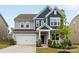 Charming two-story home featuring a two-car garage, well-manicured lawn, and inviting front entrance at 14407 Cardwell Hill Ln, Charlotte, NC 28278