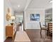 Inviting hallway featuring modern decor, warm lighting, and dark wood floors at 14407 Cardwell Hill Ln, Charlotte, NC 28278