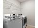 This laundry room features a washer and dryer along with wire shelving for easy storage at 14407 Cardwell Hill Ln, Charlotte, NC 28278