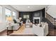 Cozy living room with a fireplace, dark accent wall, and comfortable seating, perfect for relaxing at 14407 Cardwell Hill Ln, Charlotte, NC 28278