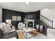 Stylish living room with a fireplace, dark accent wall, and comfortable seating and decor at 14407 Cardwell Hill Ln, Charlotte, NC 28278