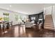 Open-concept living room with dark hardwood floors, comfortable seating, and lots of natural light at 14407 Cardwell Hill Ln, Charlotte, NC 28278