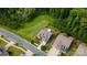 Aerial shot shows a house near a wooded area with a manicured lawn, sidewalk, and beautiful landscaping at 1467 Tranquility Blvd, Lancaster, SC 29720