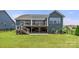 Well-maintained backyard with a spacious lawn, backing to a home with an outdoor deck and gray siding at 1467 Tranquility Blvd, Lancaster, SC 29720