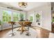 Bright breakfast nook features hardwood floors, a modern light fixture, and views of the outside through large windows at 1467 Tranquility Blvd, Lancaster, SC 29720