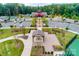 Aerial view displays a community center with parking, landscaping, an American flag, and covered seating at 1467 Tranquility Blvd, Lancaster, SC 29720