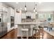 Stylish kitchen island featuring bar stool seating, granite countertops, pendant lighting, and stainless appliances at 1467 Tranquility Blvd, Lancaster, SC 29720
