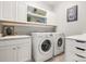 Bright laundry room with white cabinets, a sink, and a washer and dryer at 1467 Tranquility Blvd, Lancaster, SC 29720
