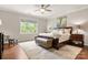 Comfortable main bedroom with a large bed, bench, and hardwood floors at 1467 Tranquility Blvd, Lancaster, SC 29720
