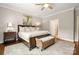 Comfortable main bedroom with a large bed, bench, and hardwood floors at 1467 Tranquility Blvd, Lancaster, SC 29720