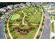 Aerial view of a community green space park with benches, playground, putting green and walking paths at 1467 Tranquility Blvd, Lancaster, SC 29720