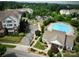 Aerial view showcasing the community pool and surrounding apartment buildings with ample parking and landscaping at 14979 Santa Lucia Dr # 2408, Charlotte, NC 28277
