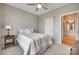 Neutral bedroom featuring plush carpet, ceiling fan and an ensuite bathroom through the doorway at 14979 Santa Lucia Dr # 2408, Charlotte, NC 28277