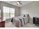 Cozy bedroom featuring plush carpet, ceiling fan and a large window at 14979 Santa Lucia Dr # 2408, Charlotte, NC 28277