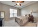 Light and airy bedroom featuring a ceiling fan, large window and plush carpet at 14979 Santa Lucia Dr # 2408, Charlotte, NC 28277