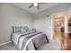 Bedroom view showing gray walls, ceiling fan, and an open doorway into the kitchen and living area at 14979 Santa Lucia Dr # 2408, Charlotte, NC 28277
