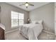 Bright bedroom featuring a ceiling fan, neutral walls, a large window and plush carpeting at 14979 Santa Lucia Dr # 2408, Charlotte, NC 28277