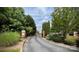 Belle Vista community entrance with gate surrounded by lush landscaping at 14979 Santa Lucia Dr # 2408, Charlotte, NC 28277