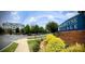 Attractive Ballantyne Village community sign, featuring landscaped grounds, shrubbery, and visible neighborhood buildings at 14979 Santa Lucia Dr # 2408, Charlotte, NC 28277