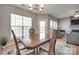 Bright dining room area with wooden table, chairs, and view of the backyard at 14979 Santa Lucia Dr # 2408, Charlotte, NC 28277