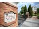 Belle Vista entrance with brick wall, manicured landscaping and stately condos in background at 14979 Santa Lucia Dr # 2408, Charlotte, NC 28277