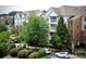 Condominium complex shows well-maintained facade, manicured landscape, and ample parking at 14979 Santa Lucia Dr # 2408, Charlotte, NC 28277