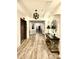 Beautifully decorated hallway with elegant console table, wood-style flooring, and modern lighting at 14979 Santa Lucia Dr # 2408, Charlotte, NC 28277