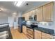 Modern kitchen featuring stainless steel appliances, granite countertops, and wood floors at 14979 Santa Lucia Dr # 2408, Charlotte, NC 28277