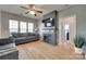 Cozy living room features a fireplace with TV, ceiling fan, and hardwood floors at 14979 Santa Lucia Dr # 2408, Charlotte, NC 28277