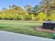 A spacious backyard with mature trees and well-kept grass at 1510 Old Rivers Rd # 171, Concord, NC 28027