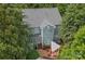 Aerial view of a two-story home with a brick patio and a pergola with outdoor seating at 15830 Waterfront Dr, Huntersville, NC 28078