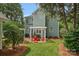 Exterior view of a home with a landscaped backyard featuring multiple patios at 15830 Waterfront Dr, Huntersville, NC 28078