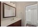 Bathroom featuring a vanity with brown cabinets, large mirror, and a shower with white curtain at 15830 Waterfront Dr, Huntersville, NC 28078