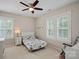Neutral toned bedroom with a ceiling fan, patterned bedding and bright, shuttered windows at 15830 Waterfront Dr, Huntersville, NC 28078