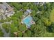 Aerial view of a community pool surrounded by trees, lounge chairs, and neighborhood homes at 15830 Waterfront Dr, Huntersville, NC 28078