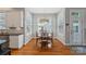 Charming dining area with hardwood floors, ample windows, and a stylish light fixture at 15830 Waterfront Dr, Huntersville, NC 28078