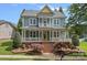 Charming two-story home featuring a welcoming front porch, beautiful landscaping, and classic architectural details at 15830 Waterfront Dr, Huntersville, NC 28078