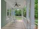 Relaxing front porch with rocking chairs and ceiling fan, perfect for enjoying the outdoors at 15830 Waterfront Dr, Huntersville, NC 28078