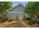 Side view of the detached garage with a vibrant yellow door and manicured landscaping at 15830 Waterfront Dr, Huntersville, NC 28078